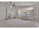 Spacious living room with neutral carpet, fan, and front door view enhanced by a large mirror at 501 Hiddenbrook Dr, Durham, NC 27703