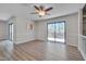 Bright living area with wood floors and sliding glass doors to deck offers a seamless indoor-outdoor experience at 501 Hiddenbrook Dr, Durham, NC 27703