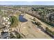 Expansive aerial view showcases a lush golf course with a scenic pond and surrounding mature trees at 512 Hallburg Ct, Wake Forest, NC 27587