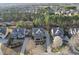 An aerial view of a suburban neighborhood featuring a home nestled among mature trees and well-manicured lawns at 512 Hallburg Ct, Wake Forest, NC 27587