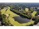 Scenic aerial view of a golf course with a pond, surrounded by trees and homes in a residential neighborhood at 512 Hallburg Ct, Wake Forest, NC 27587