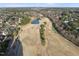 Expansive aerial view showcases a lush golf course with a scenic pond and surrounding mature trees at 512 Hallburg Ct, Wake Forest, NC 27587