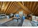 Unfinished attic space featuring exposed framing, a window, and storage boxes at 512 Hallburg Ct, Wake Forest, NC 27587
