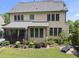 Two-story home boasts a large, well-manicured yard featuring mature landscaping, a screened porch, and patio at 512 Hallburg Ct, Wake Forest, NC 27587