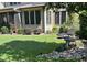 Manicured backyard featuring a rock water feature, lush greenery, and well-maintained landscaping at 512 Hallburg Ct, Wake Forest, NC 27587