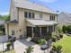 Exterior of home with a spacious backyard including a screened porch, patio, and lush landscaping at 512 Hallburg Ct, Wake Forest, NC 27587