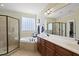 Bathroom featuring a corner tub, a double vanity, a large mirror and glass-enclosed shower at 512 Hallburg Ct, Wake Forest, NC 27587