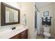 Bathroom with a single sink vanity, framed mirror, and a shower-tub combination at 512 Hallburg Ct, Wake Forest, NC 27587