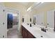 Well-lit bathroom featuring a double vanity with granite counters and a private shower/toilet area at 512 Hallburg Ct, Wake Forest, NC 27587