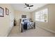 Neutral-toned bedroom with a metal bed frame, ceiling fan, large window, and a closet at 512 Hallburg Ct, Wake Forest, NC 27587