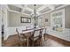 Elegant dining room with coffered ceilings, hardwood floors, and abundant natural light from large windows at 512 Hallburg Ct, Wake Forest, NC 27587