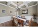 Elegant dining room with coffered ceilings, hardwood floors, and abundant natural light from large windows at 512 Hallburg Ct, Wake Forest, NC 27587