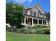 Charming two-story home with a welcoming front porch and beautifully landscaped front yard at 512 Hallburg Ct, Wake Forest, NC 27587