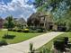 Charming two-story home with a long driveway and mature trees in a suburban neighborhood at 512 Hallburg Ct, Wake Forest, NC 27587