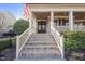 Inviting front porch with brick steps, white railings, and American flag for curb appeal at 512 Hallburg Ct, Wake Forest, NC 27587