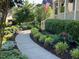 A winding walkway leads to a home's entrance, surrounded by lush greenery and landscape lighting at 512 Hallburg Ct, Wake Forest, NC 27587