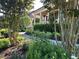 A winding walkway leads to a home's entrance, surrounded by lush greenery and landscape lighting at 512 Hallburg Ct, Wake Forest, NC 27587