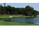 Scenic view of a lush green golf course with a tranquil pond, sand traps, and well-manicured lawns at 512 Hallburg Ct, Wake Forest, NC 27587