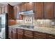 Kitchen featuring granite countertops, tiled backsplash, and stainless steel appliances at 512 Hallburg Ct, Wake Forest, NC 27587