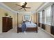 A traditionally decorated primary bedroom featuring a four-poster bed, ceiling fan, and natural light at 512 Hallburg Ct, Wake Forest, NC 27587