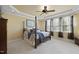 Elegant main bedroom with tray ceiling, four-poster bed, and large windows at 512 Hallburg Ct, Wake Forest, NC 27587