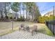Outdoor patio with brick pavers and outdoor furniture, surrounded by green trees at 512 Hallburg Ct, Wake Forest, NC 27587