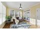 Cozy sunroom with lots of natural light, a leather couch, and view of the backyard at 512 Hallburg Ct, Wake Forest, NC 27587