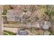 Bird's eye view of the property showcasing its backyard, unique shed, and tree coverage at 529 Hillcrest Ave, Burlington, NC 27215