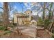 View of the wooden deck and backyard of the yellow house with interesting design elements at 529 Hillcrest Ave, Burlington, NC 27215