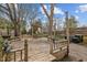 Spacious wooden deck and backyard with mature trees and shade for outdoor enjoyment at 529 Hillcrest Ave, Burlington, NC 27215