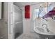 Traditional bathroom featuring a stand-up shower, pedestal sink, window with shutter, and red storage cabinet at 529 Hillcrest Ave, Burlington, NC 27215