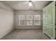 Bright bedroom featuring carpet, three windows with blinds, and a closet at 529 Hillcrest Ave, Burlington, NC 27215