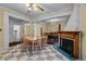 Open-concept dining area with checkered floors, fireplace, and views into the living room and kitchen at 529 Hillcrest Ave, Burlington, NC 27215