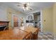Inviting dining room featuring natural light and a classic ceiling fan, seamlessly connecting to the kitchen at 529 Hillcrest Ave, Burlington, NC 27215