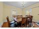 Elegant dining room features hardwood floors, a large table with seating for ten, and natural light at 529 Hillcrest Ave, Burlington, NC 27215