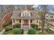 Charming yellow home with inviting front porch, landscaped yard and mature trees at 529 Hillcrest Ave, Burlington, NC 27215