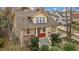 Charming yellow home with a gray roof, red front porch, and mature trees surrounding the property at 529 Hillcrest Ave, Burlington, NC 27215