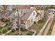 Aerial view of a two-story yellow home with a gray roof, mature trees, and a yard with a white fence at 529 Hillcrest Ave, Burlington, NC 27215