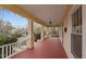 Long, open-air front porch with painted wood floors and ceilings at 529 Hillcrest Ave, Burlington, NC 27215