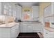 This kitchen features white cabinets, tiled countertops, and essential appliances for easy meal preparation at 529 Hillcrest Ave, Burlington, NC 27215