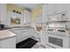 Well-lit kitchen boasts ample storage, white cabinets, and functional appliances for a cozy cooking experience at 529 Hillcrest Ave, Burlington, NC 27215