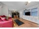 Open-concept living space with hardwood floors, built-in shelving, and a ceiling fan for comfortable living at 529 Hillcrest Ave, Burlington, NC 27215
