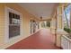 Spacious front porch with painted wood flooring, decorative columns, and charming exterior lighting at 529 Hillcrest Ave, Burlington, NC 27215