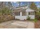 Exterior of shed with unique design with bright white paint and updated windows at 529 Hillcrest Ave, Burlington, NC 27215
