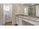 Bathroom showcases vanity with granite countertop, complemented by natural light and white cabinetry at 5320 River Reach Dr, Raleigh, NC 27616