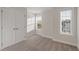 Bright bedroom with neutral carpet, white trim, and natural light streaming through two windows at 5320 River Reach Dr, Raleigh, NC 27616