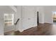 Hallway with wood floors, white trim and doors, and a window with natural light at 5320 River Reach Dr, Raleigh, NC 27616