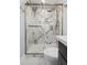New bathroom showcasing marble shower, gold fixtures, and glass door at 5812 Timber Ridge Dr, Raleigh, NC 27609
