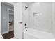 Bright bathroom featuring white subway tiles and a soaking tub with matte black fixtures at 5812 Timber Ridge Dr, Raleigh, NC 27609