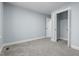 Bedroom with neutral walls and carpet, and an open closet at 5812 Timber Ridge Dr, Raleigh, NC 27609